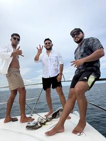 A group of friends poses on the deck of a boat, enjoying their time on the water — perfect for memorable outings and celebrations.