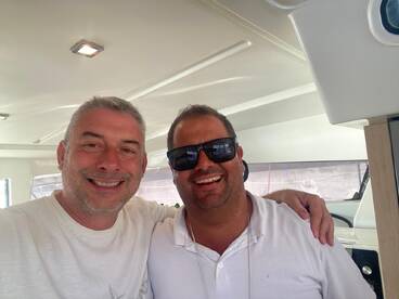Two friends pose for a cheerful selfie inside a boat, showcasing camaraderie and the joy of boating adventures.