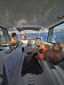 A lively group enjoys a relaxing moment aboard a boat, showcasing family fun and camaraderie on the water.