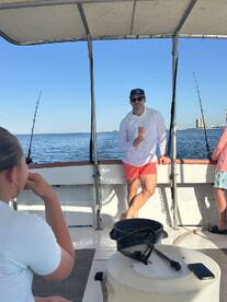 Guests enjoy a fishing trip on the open ocean, capturing the essence of a fun day on the water with friends.