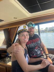 A happy couple enjoys their time aboard a boat, showcasing a fun and celebratory atmosphere perfect for memorable outings on the water.