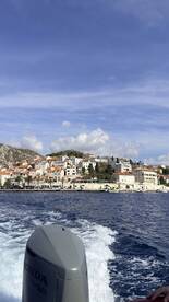 A scenic view of a coastal town from a boat, showcasing charming architecture and vibrant waterfront life — perfect for exploring picturesque destinations.
