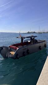 A sleek Phantom 10 boat is seen underway, showcasing its modern design and powerful Honda engine, perfect for cruising in style.