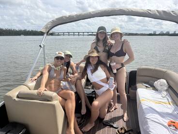 A lively group of friends enjoys a fun day on a pontoon boat, showcasing the perfect atmosphere for summer celebrations and water activities.