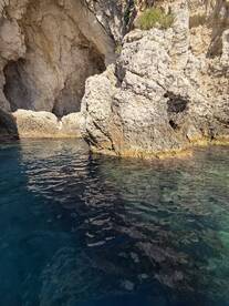 A stunning view of a rocky coastline with clear waters, perfect for exploring hidden coves and enjoying the natural beauty of the sea.