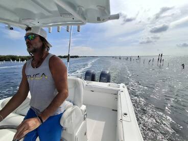 A captain navigates a boat through scenic waters, showcasing the thrill of on-water adventures and exploration.