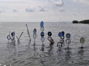 An unclear view of floating markers in shallow water, possibly indicating a scenic spot or activity area.