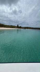 A serene view of turquoise waters and a sandy beach, perfect for a relaxing day on the water or exploring beautiful coastal destinations.