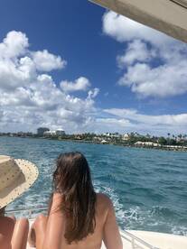 Two friends enjoy a scenic boat ride, taking in the beautiful ocean views and coastal landscape — a perfect moment for relaxation and adventure.
