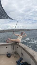 A joyful moment captured as a young woman enjoys the boat ride, showcasing the fun and excitement of a day on the water.