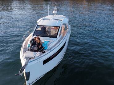 A couple enjoys a moment on the deck of a stylish boat, perfect for romantic outings or special celebrations on the water.