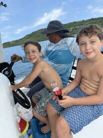 Two smiling boys enjoy a fun day on the boat, capturing the joy of family adventures on the water.