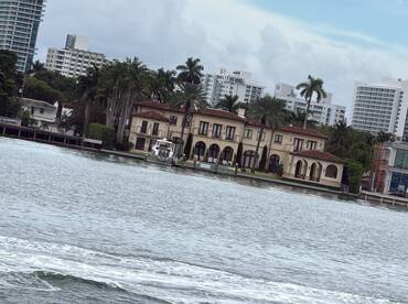 A view of a waterfront property with a boat docked nearby, but the image lacks clarity and detail.