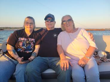 A cheerful group of friends enjoys a sunset on a boat, capturing a perfect moment of camaraderie and relaxation on the water.