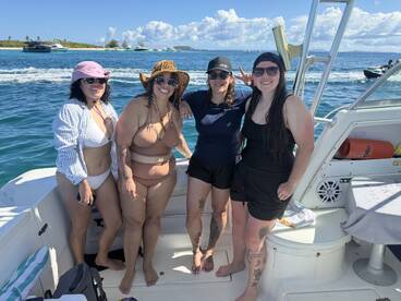 A fun group of friends poses together on a boat, enjoying their time on the water — perfect for memorable outings and celebrations.