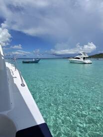 A stunning view of two boats anchored in crystal-clear waters, showcasing the beauty of a serene marine environment — perfect for a day of relaxation and exploration.
