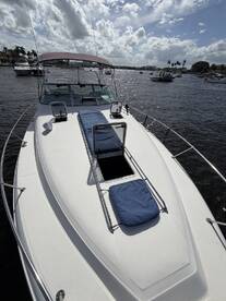 A clear view of the front deck of a yacht, showcasing its sleek design and inviting space, perfect for relaxing on the water.