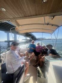 A lively group enjoys drinks aboard a boat, creating memorable moments under the sun — perfect for celebrations and gatherings on the water.