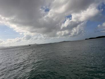 A scenic view of the water and clouds, but the image lacks clarity and focus.