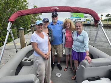 A cheerful group of friends poses together on a pontoon boat, ready for a day of fun on the water. Perfect for creating lasting memories during boating adventures.